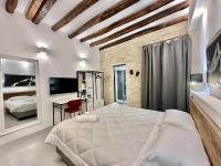 Posteľ alebo postele v izbe v ubytovaní C&O Savoia Deluxe Rooms