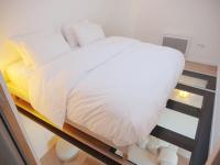 a bedroom with a bed with white sheets and pillows at Magnifique cocon in Amiens