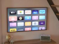 a television screen with a bunch of apps on it at Magnifique cocon in Amiens
