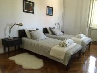 a living room with two beds and a rug at Villa Peppina Apartment in Lovran