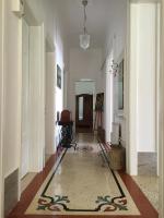 a hallway with white walls and a rug on the floor at Villa Peppina Apartment in Lovran
