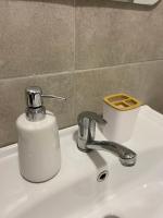a soap dispenser sitting on a bathroom sink at Kula Dream apartment in Kula
