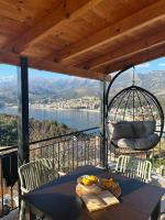 a table on a balcony with a view of the water at Hostel on the Hill - by Filikuri Beach in Himare