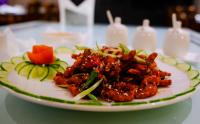 a plate of food on a table at Finn's Weaver Resort, Kaziranga in Kāziranga