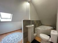 a bathroom with a toilet and a sink and a tub at CASA COLIVING avec chambre salle de bain individuelles privatives in Saint-Pierre