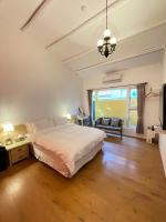 a bedroom with a large bed and a large window at Alishan Tea Garden B&amp;B in Fenqihu