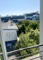 a view of a garden from a balcony at La Désirade by Póm in Lorient
