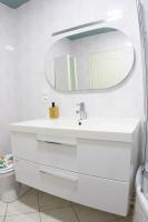 a white bathroom with a sink and a mirror at Kasa Jura 2 - Centre ville - Proche pistes de ski in Saint-Claude