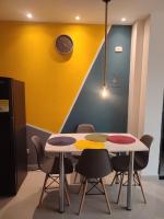 a dining room with two tables and chairs at 201-Cómodo y moderno apartamento de 2 habitaciones en la mejor zona céntrica de ibagué in Ibagué