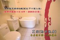 a bathroom with a white toilet and a sink at Tingtau Villa in Lugu Lake