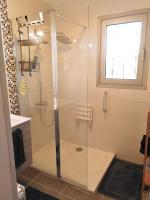 a shower with a glass door in a bathroom at Appart T3 Spacieux + Terrasse in Montpellier