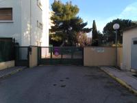 an empty parking lot with a gate in front of a building at Appart T3 Spacieux + Terrasse in Montpellier