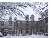a large brick building with snow on it at La Maison Saint Joseph in Crépy-en-Valois