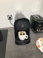 a coffee maker with a cup of coffee on a counter at Nuits centre : superbe gîte rénové et climatisé in Nuits-Saint-Georges