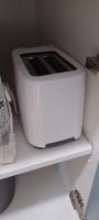 a white toaster sitting on top of a shelf at NANA A33 Appartement 2 Chambres Climatisées cuisine équipée Netflix in Cayenne