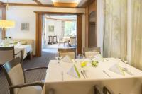 策勒Hotel Celler Tor的摆放着白色桌椅的餐厅