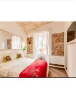 a bedroom with a large white bed and a window at Bretone XI b&amp;b in Rome