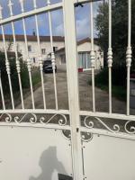 a gate in front of a house at chambre violette coté aéroport calme charmante in Pusignan