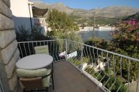 a balcony with a table and a view of the water at Apartments by the sea Slano, Dubrovnik - 8538 in Slano