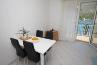 a dining room with a white table and chairs at Apartments by the sea Slano, Dubrovnik - 8538 in Slano
