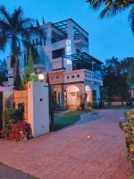 a large white building with a palm tree in front of it at White Palace B&amp;B in Ji&#39;an