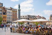 a group of people sitting at tables in a city at Marcq-en-Baroeul - beautiful fully equipped ! 2p in Marcq-en-Baroeul