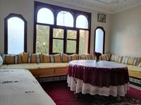 a living room with a couch and a table at Gite chez Ali Agouti Maison Berbère in Agouti
