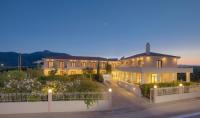 a large house with lights on it at night at Kyniska Hotel in Plytra