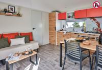 a living room and kitchen with a couch and a table at Camping La Mignardière in Ballan-Miré