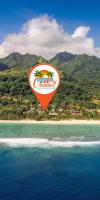 an orange heart shaped kite flying over a beach at The Cooks Oasis in Rarotonga