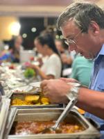 a man is preparing food at a buffet at Wadi Rum Desert Tours and Glamping with Hussein in Wadi Rum