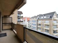 a balcony with a view of a building at Blomme 0202 exclusive apartment with sea view in De Haan