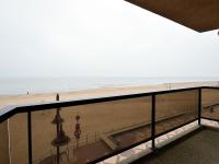 a view of the beach from the balcony of a building at Blomme 0202 exclusive apartment with sea view in De Haan