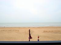 a view of a beach with the ocean in the background at Blomme 0202 exclusive apartment with sea view in De Haan
