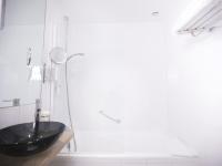 a bathroom with a black sink and a shower at Tiercé Hotel in Cagnes-sur-Mer