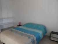 a bedroom with a bed with a blue blanket at La casa en el campo A 20 minutes de Zoo Beauval &amp; 8 minutes de la flamme olympique à Valençay in Vicq-sur-Nahon