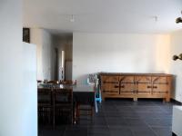 a dining room with a table and wooden cabinets at La casa en el campo A 20 minutes de Zoo Beauval &amp; 8 minutes de la flamme olympique à Valençay in Vicq-sur-Nahon