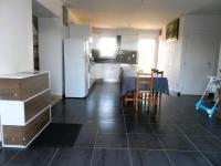 a kitchen and dining room with a table and a refrigerator at La casa en el campo A 20 minutes de Zoo Beauval &amp; 8 minutes de la flamme olympique à Valençay in Vicq-sur-Nahon