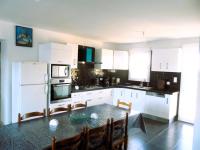 a kitchen with white cabinets and a table with chairs at La casa en el campo A 20 minutes de Zoo Beauval &amp; 8 minutes de la flamme olympique à Valençay in Vicq-sur-Nahon