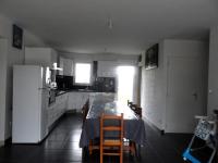 a kitchen with a table with chairs and a refrigerator at La casa en el campo A 20 minutes de Zoo Beauval &amp; 8 minutes de la flamme olympique à Valençay in Vicq-sur-Nahon