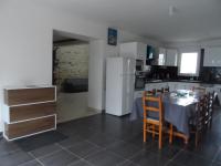 a kitchen with a table and a white refrigerator at La casa en el campo A 20 minutes de Zoo Beauval &amp; 8 minutes de la flamme olympique à Valençay in Vicq-sur-Nahon