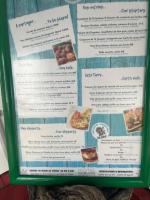 een menu voor een restaurant met eten erop bij ocean view, on the beach. in Le Gosier