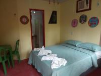 a bedroom with a bed with towels on it at Pousada Grão in Belém