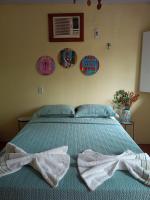 a bedroom with a bed with two bows on it at Pousada Grão in Belém