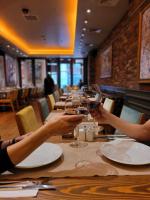 two people sitting at a table with glasses of wine at Pera Tulip Hotel & Spa in Istanbul