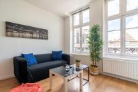 a living room with a couch and a table at Vieux Lille appartement 1 chambre in Lille