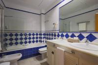 a bathroom with a sink and a toilet and a mirror at Hotel Tugasa Castillo de Castellar in Castellar de la Frontera