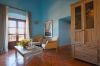 a living room with a cabinet and a table at Hotel Tugasa Castillo de Castellar in Castellar de la Frontera