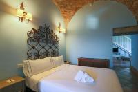 a bedroom with a bed with two towels on it at Hotel Tugasa Castillo de Castellar in Castellar de la Frontera