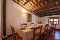a dining room with a long table and chairs at Hotel Tugasa Castillo de Castellar in Castellar de la Frontera